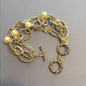 Silver, multi-strand bracelet with faux pearls.